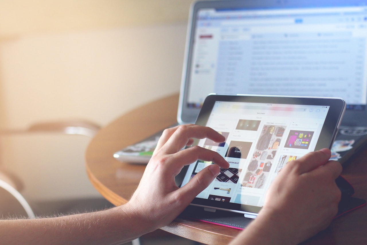 person watching items on ipad for shopping