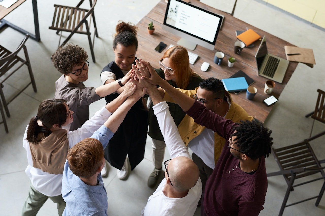 a group of people holding each other hands to show teamwork